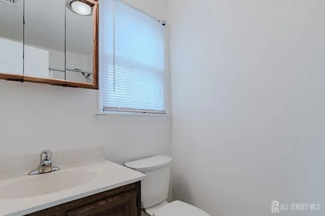 a bathroom with a sink a toilet and vanity