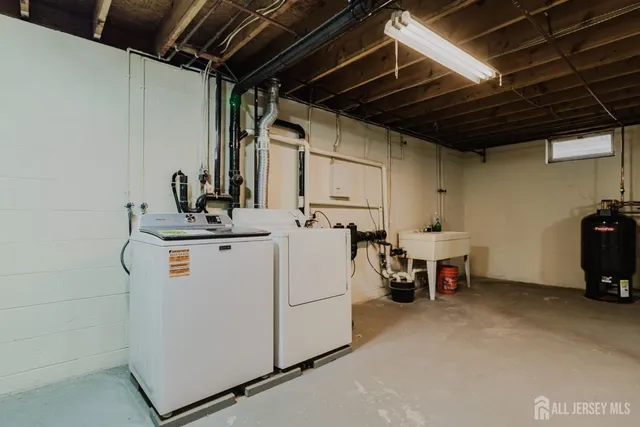 a view of storage and utility room with washer and dryer