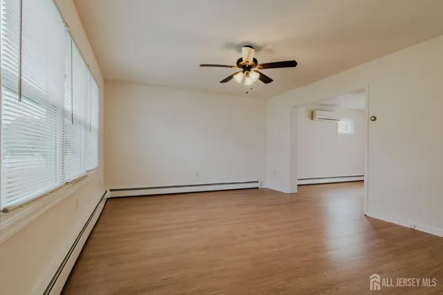 a view of room with hardwood floor and ceiling fan