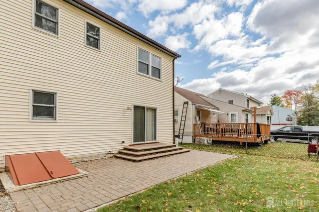a view of a white house in the back yard of the house