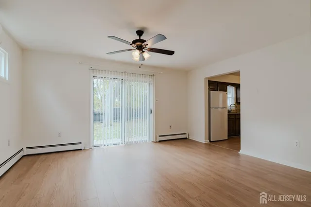 a view of room with hardwood floor and ceiling fan