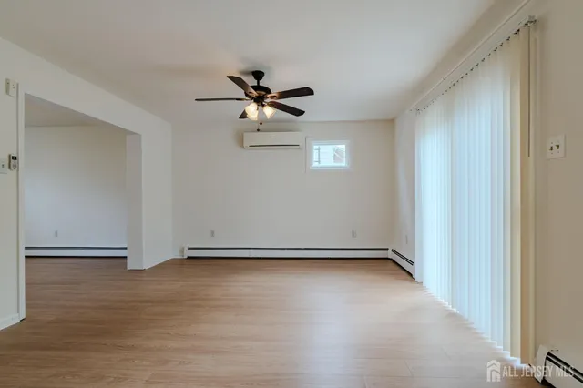 a view of room with hardwood floor and ceiling fan