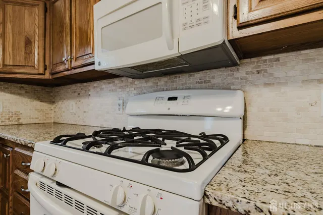 a kitchen with a stove and a microwave