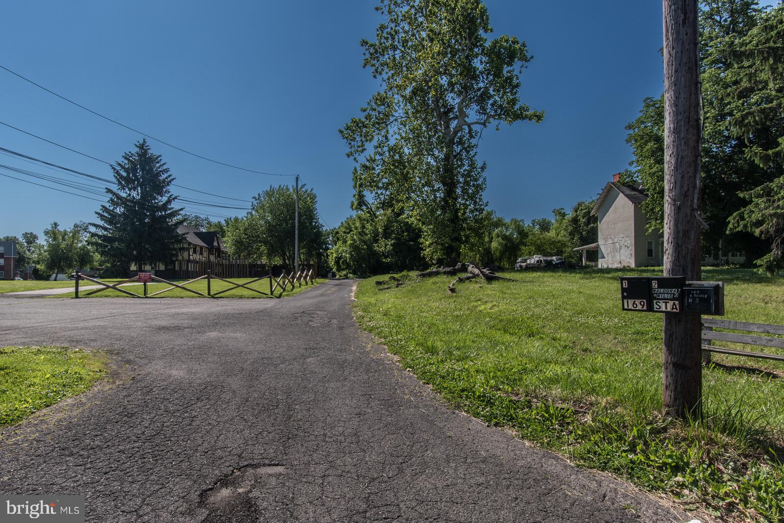 169 State Rd. Bensalem, PA 19020 - Photo 4 of 100 a view of a street with a yard