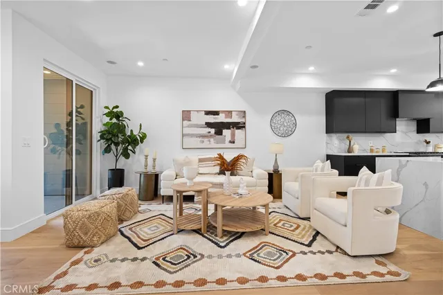 a spacious bedroom with a bed a couch and a potted plant