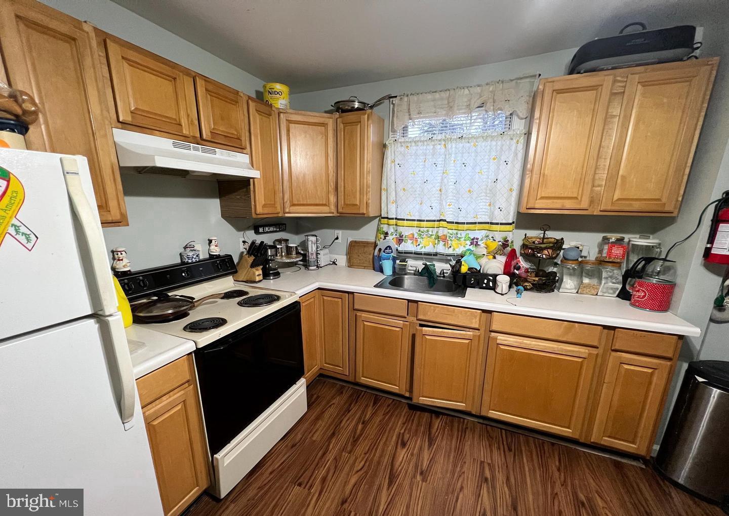 911 Laurel Road Lindenwold, NJ 08021 - Photo 14 of 20 a kitchen with stainless steel appliances granite countertop wooden cabinets a stove a sink and a refrigerator
