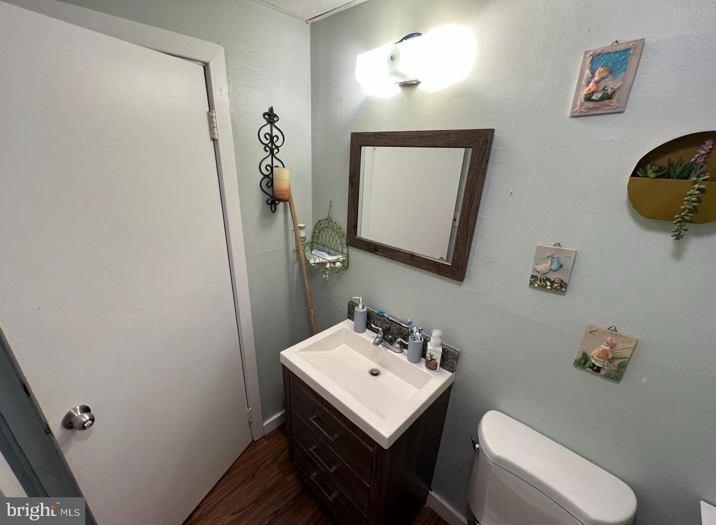 911 Laurel Road Lindenwold, NJ 08021 - Photo 17 of 20 a bathroom with a toilet a sink and mirror