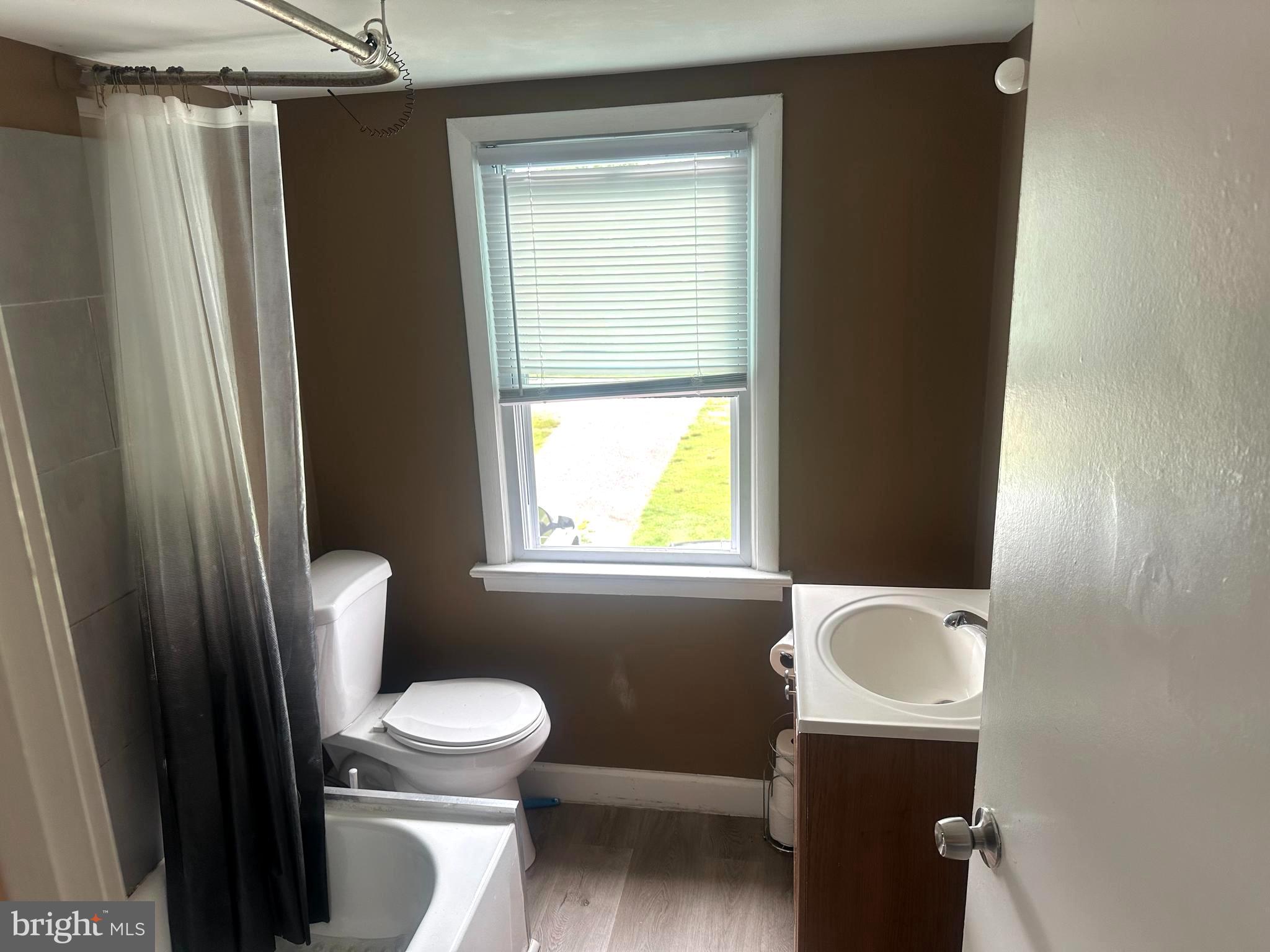 911 Laurel Road Lindenwold, NJ 08021 - Photo 4 of 20 a white toilet sitting next to a bathroom sink and a tub