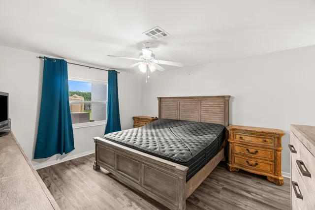 a bedroom with a bed and a chandelier