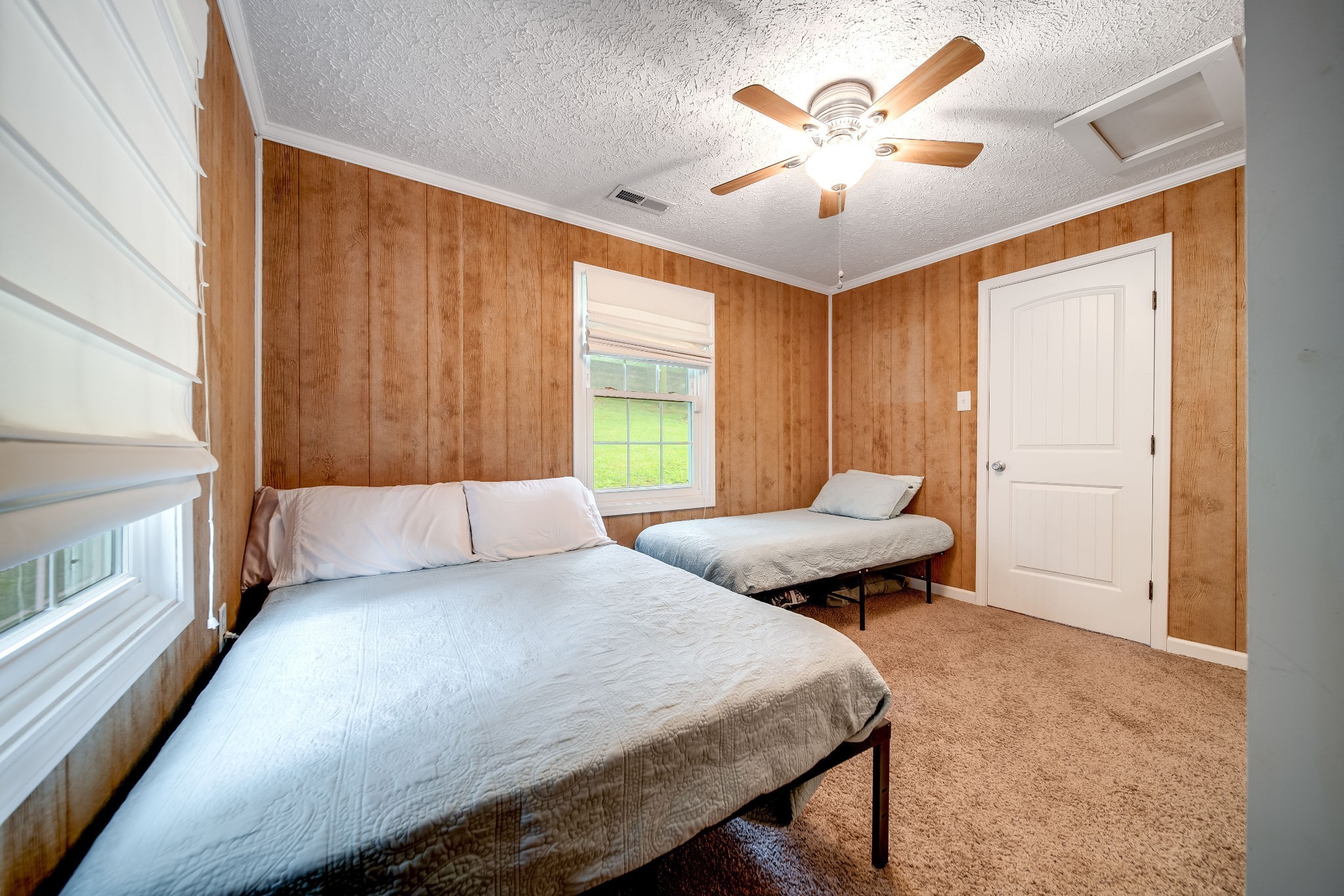 554 Hickman Shores Road Dover, TN 37058 - Photo 24 of 93 a bedroom with a bed and a chandelier