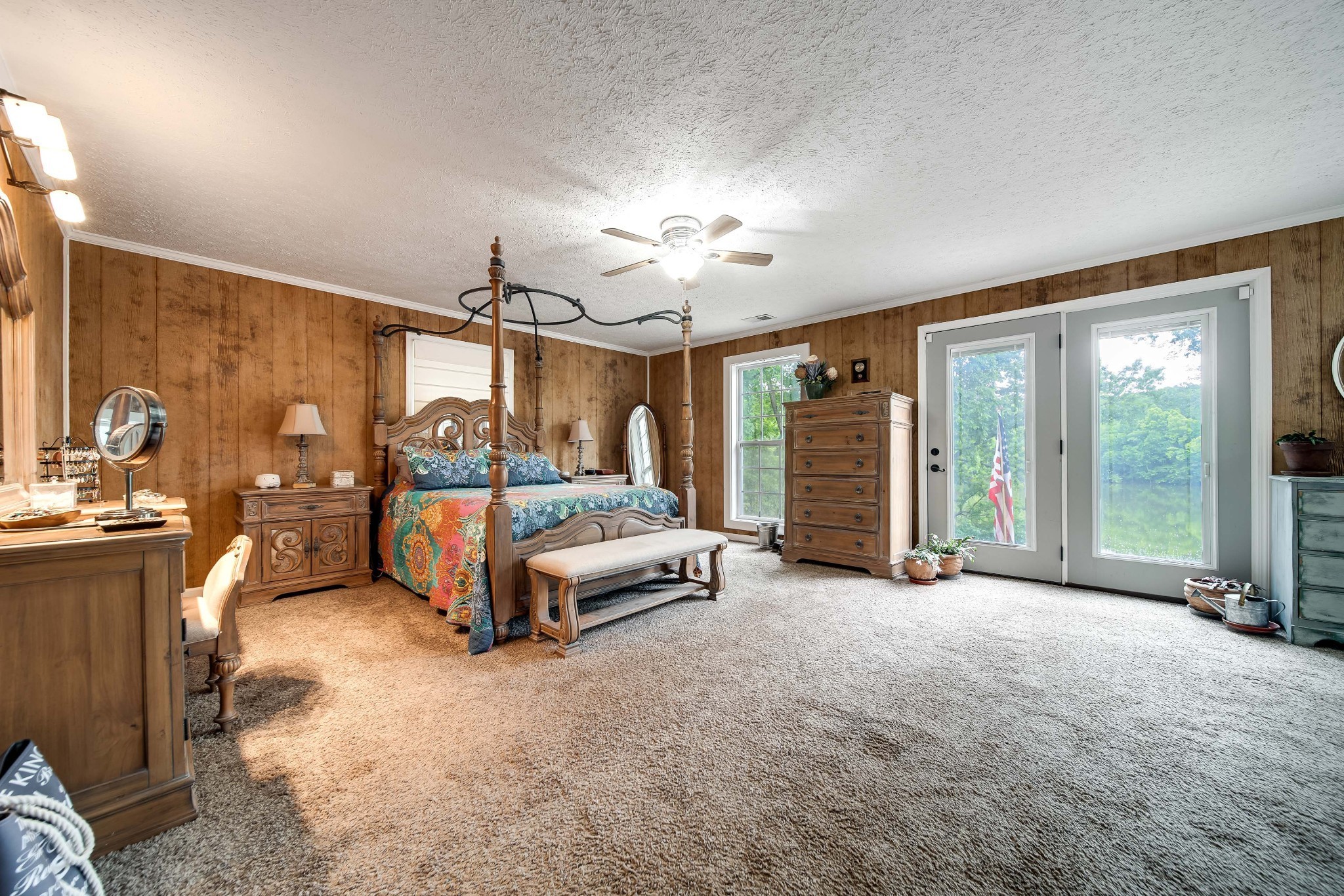 554 Hickman Shores Road Dover, TN 37058 - Photo 29 of 93 a spacious bedroom with a large bed and a chandelier