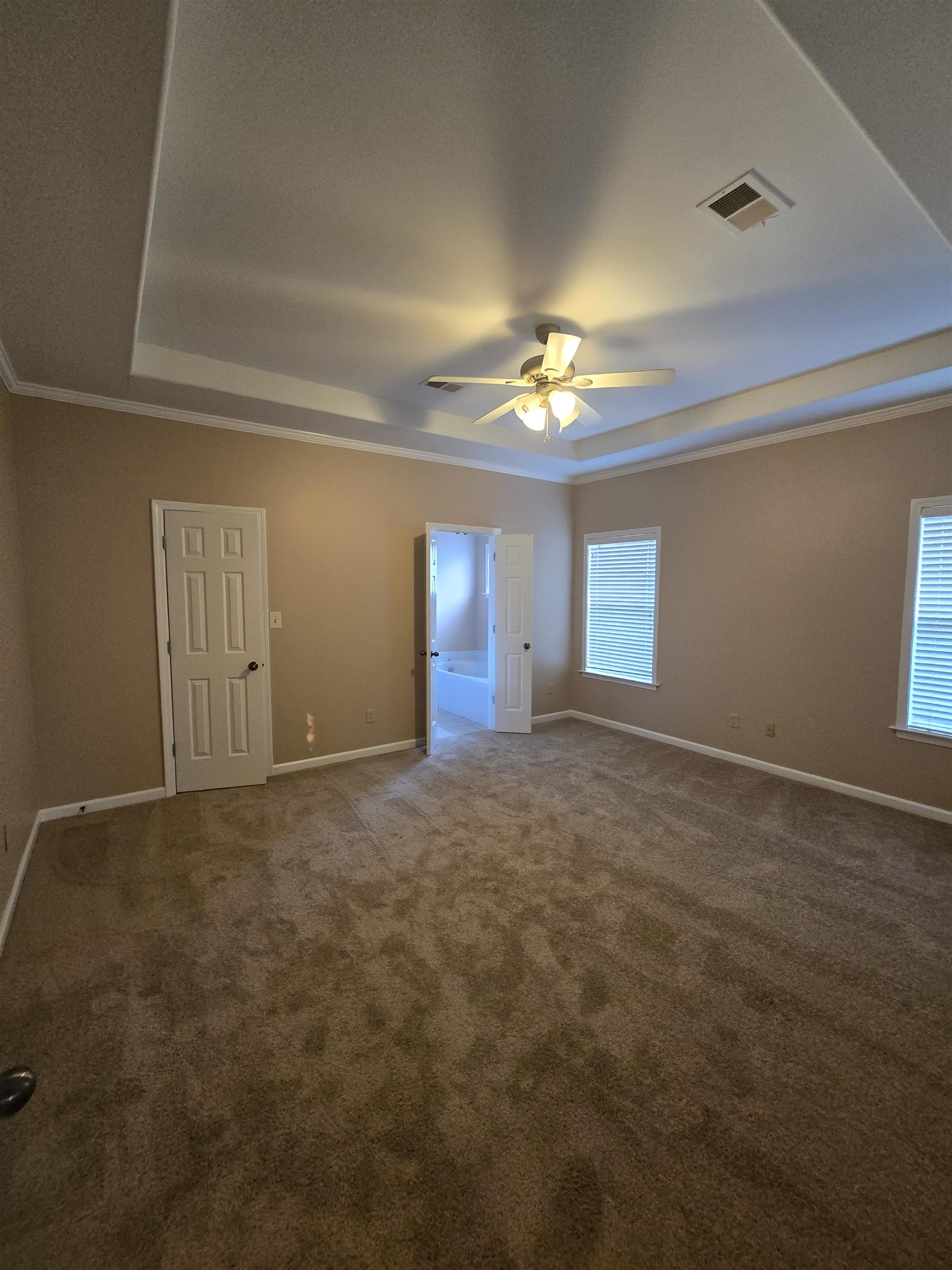 5186 Guffin Road Bartlett, TN 38135 - Photo 10 of 21 Empty room with a ceiling fan, a raised ceiling, carpet floors, and crown molding