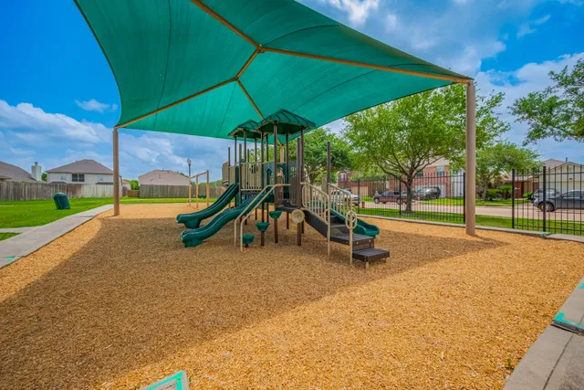 a view of a street with a yard and lake view