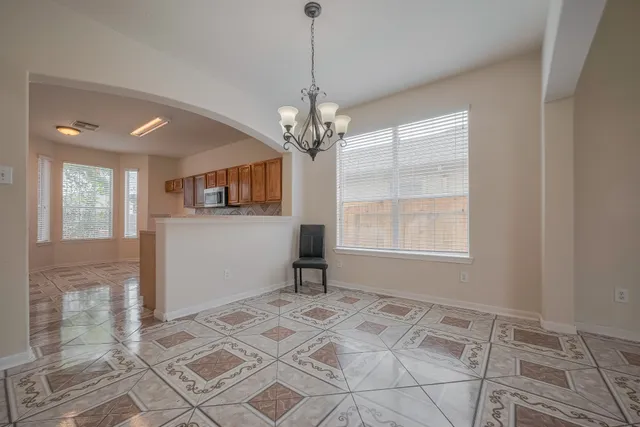 a view of a room with window and chandelier