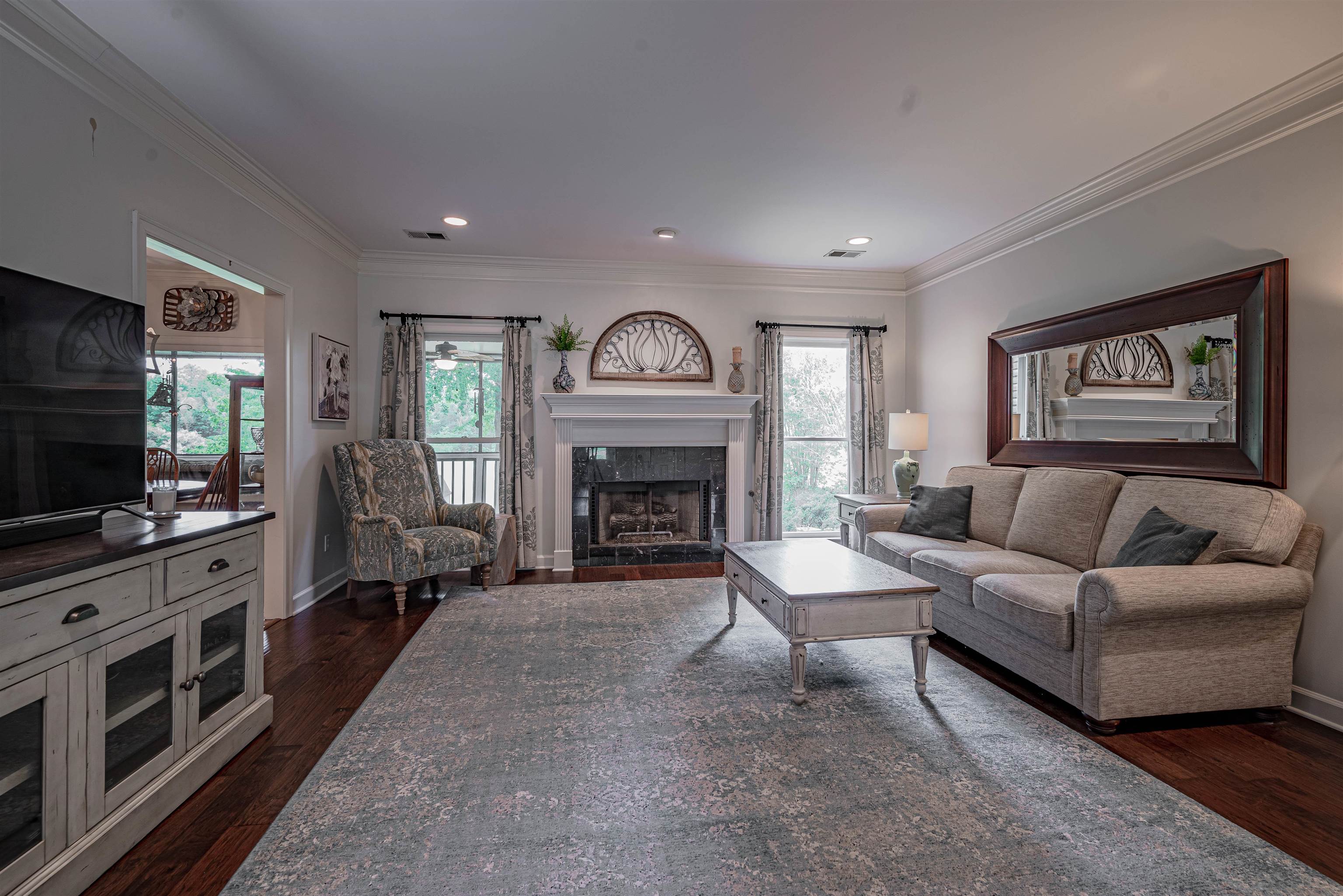 752 Gable Lane Collierville, TN 38017 - Photo 3 of 40 a living room with furniture a flat screen tv and a fireplace