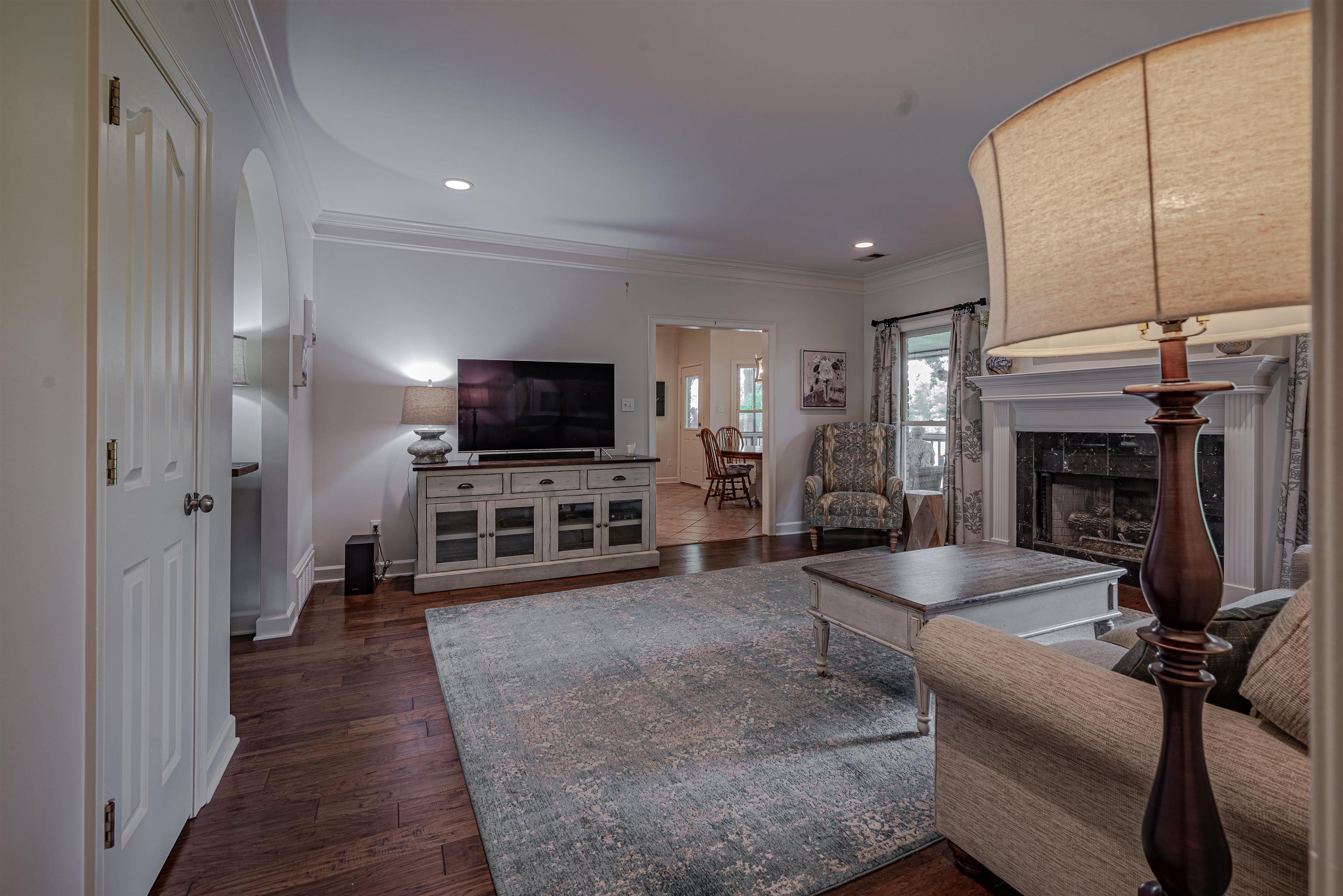 752 Gable Lane Collierville, TN 38017 - Photo 4 of 40 a living room with furniture a flat screen tv and a fireplace