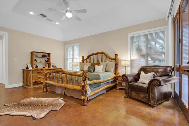 a bedroom with a bed and a large window