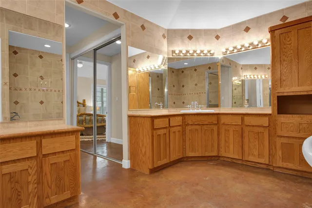 a bathroom with a double vanity sink and a mirror