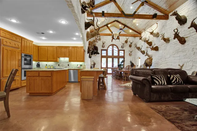 a dining room with furniture floor to ceiling windows and a rug