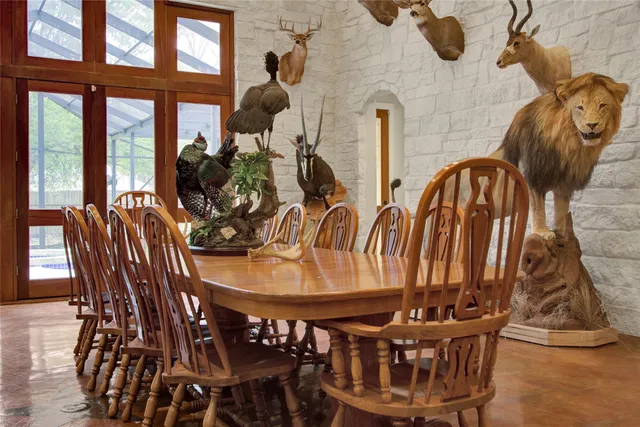 a dining room with furniture and wooden floor
