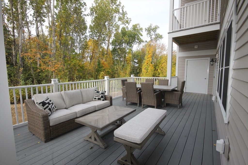 1 Regency Village Way, Unit 316 Merrimac, MA 01860 - Photo 17 of 25 a roof deck with couches and wooden floor
