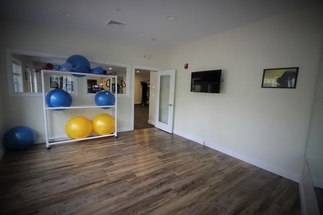 a room with wooden floor and large window