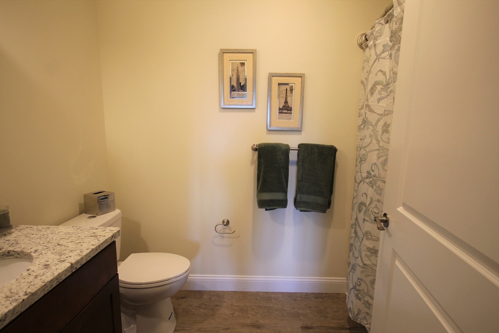 1 Regency Village Way, Unit 316 Merrimac, MA 01860 - Photo 9 of 25 a bathroom with a granite countertop toilet and a shower