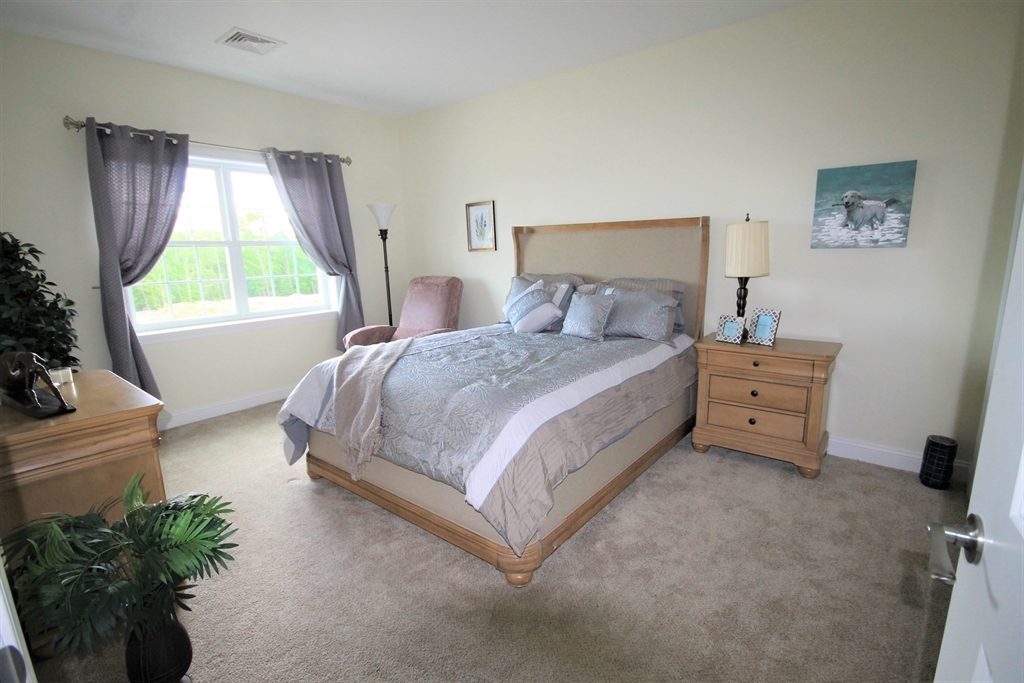 1 Regency Village Way, Unit 316 Merrimac, MA 01860 - Photo 10 of 25 a bedroom with a bed and a window