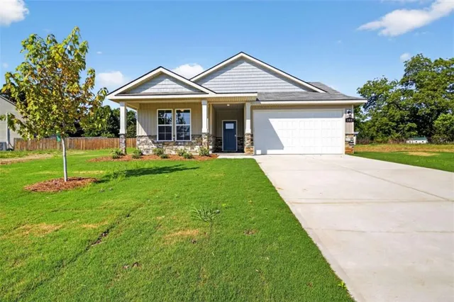 a front view of a house with a yard and porch