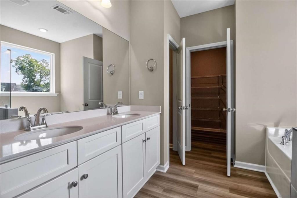 103 Gnome Court Perry, GA 31069 - Photo 16 of 30 a bathroom with a double vanity sink and a mirror