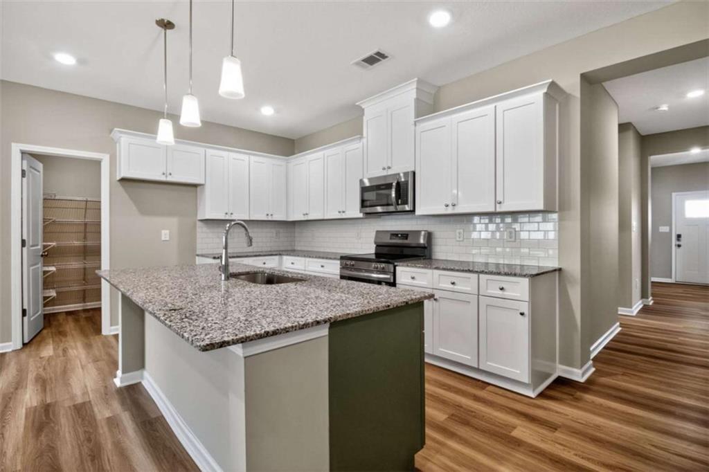 103 Gnome Court Perry, GA 31069 - Photo 17 of 30 a kitchen with stainless steel appliances granite countertop a sink stove and refrigerator