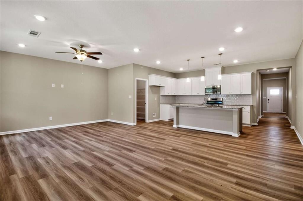 103 Gnome Court Perry, GA 31069 - Photo 18 of 30 an open kitchen with kitchen island a stove and a refrigerator