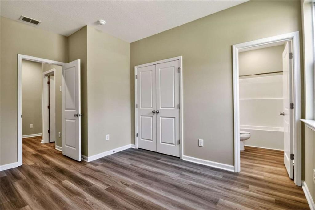 103 Gnome Court Perry, GA 31069 - Photo 20 of 30 an empty room with wooden floor cabinet and windows