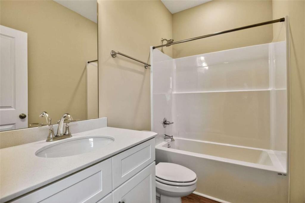 103 Gnome Court Perry, GA 31069 - Photo 23 of 30 a bathroom with a granite countertop sink toilet and shower