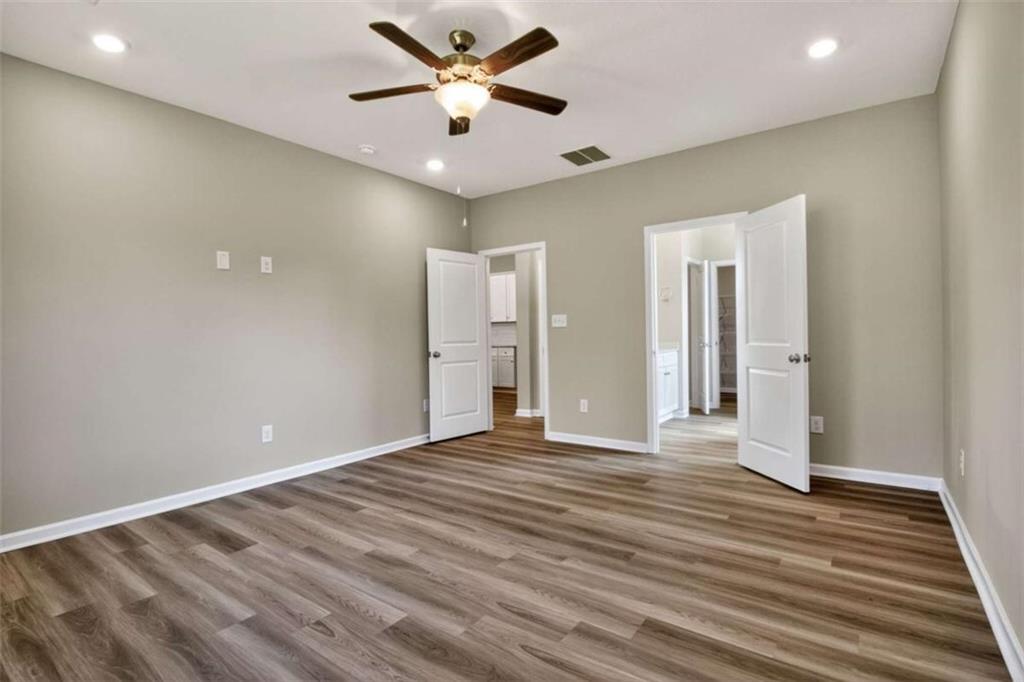 103 Gnome Court Perry, GA 31069 - Photo 24 of 30 a view of an empty room with wooden floor and a ceiling fan