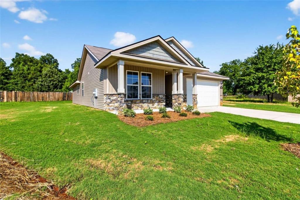 103 Gnome Court Perry, GA 31069 - Photo 3 of 30 a front view of a house with a garden and sitting area