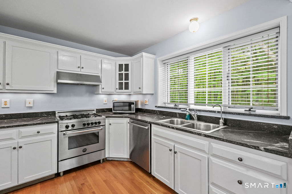 88 Powder Hill Road Middlefield, CT 06455 - Photo 16 of 40 a kitchen with granite countertop a sink a window and stainless steel appliances