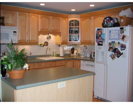 28 Mountain Gate Road, Unit 28 Ashland, MA 01721 - Photo 2 of 5 a kitchen with a refrigerator and a sink