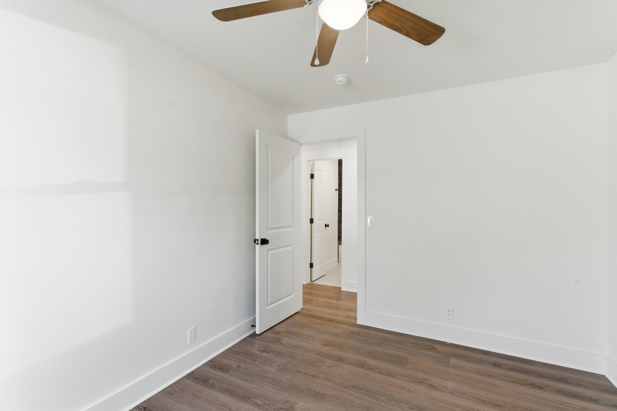 206 New Sawyer Brown Road Nashville, TN 37221 - Photo 17 of 46 a view of an empty room with wooden floor