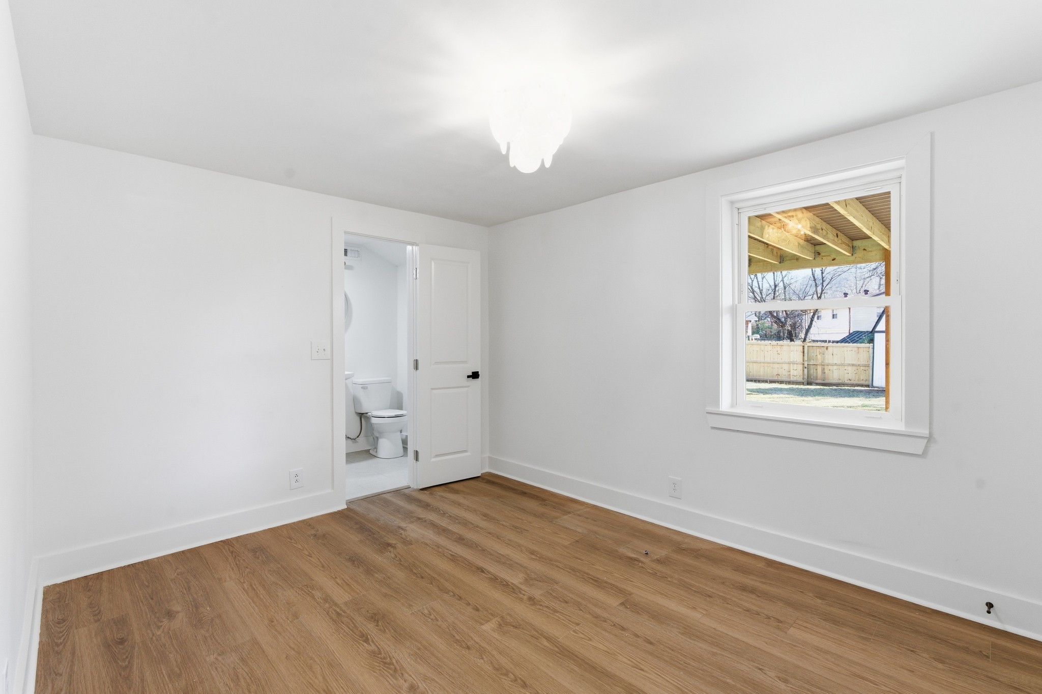 206 New Sawyer Brown Road Nashville, TN 37221 - Photo 23 of 46 a view of empty room with wooden floor and fan