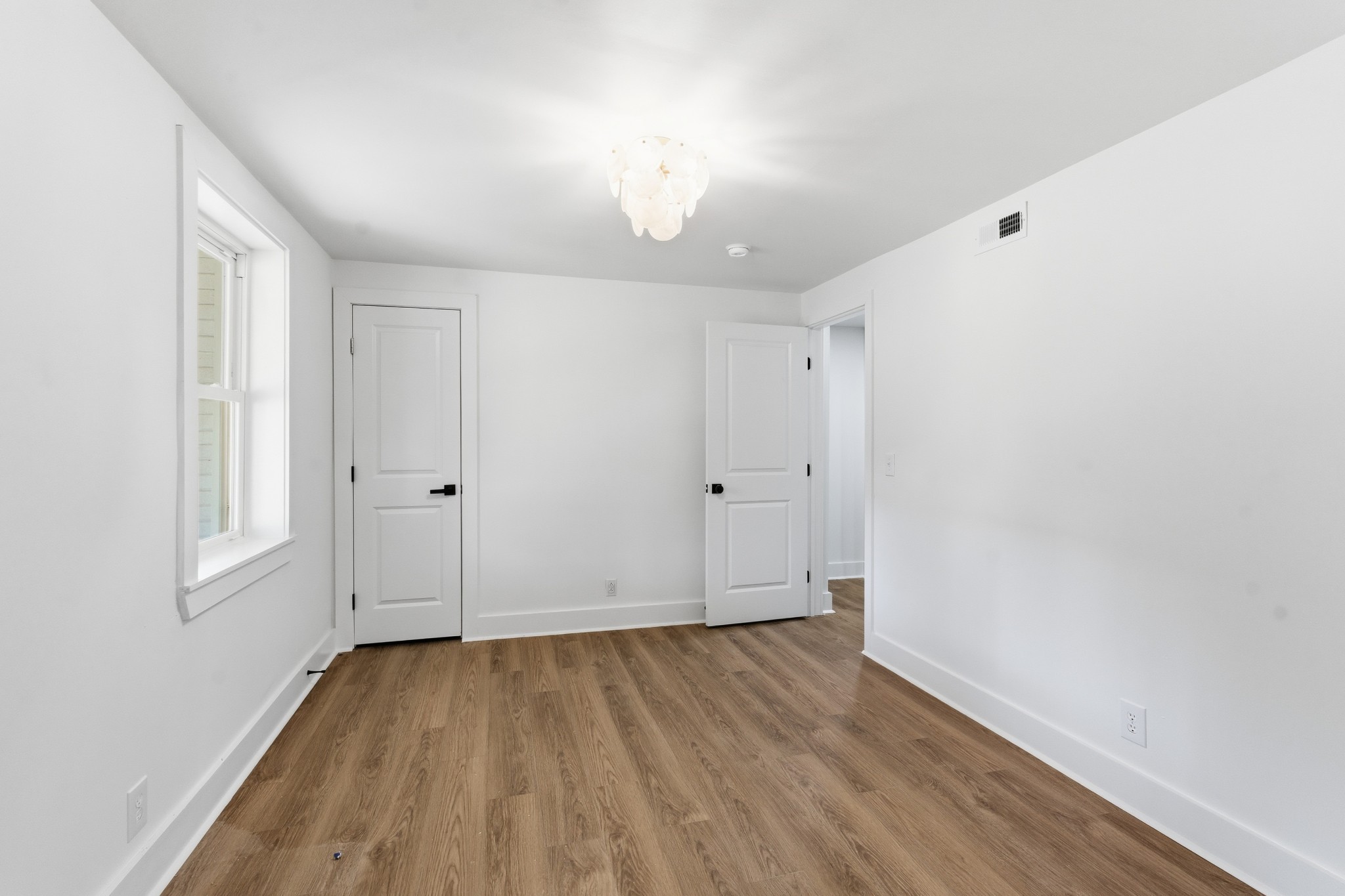 206 New Sawyer Brown Road Nashville, TN 37221 - Photo 24 of 46 an empty room with wooden floor and windows