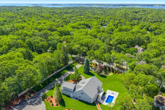a living room with furniture a large window and a fireplace