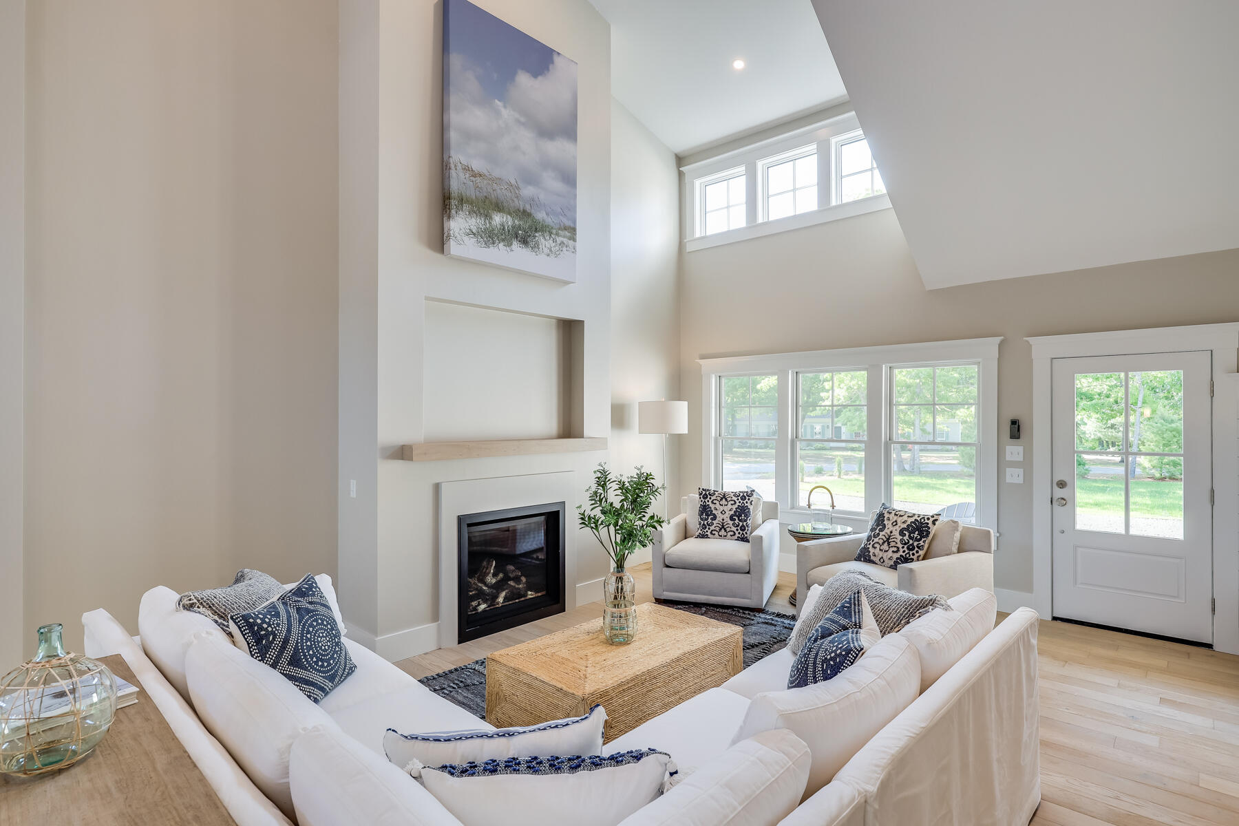 2 Monomoy Lane Orleans, MA 02653 - Photo 13 of 27 a living room with furniture a large window and a fireplace