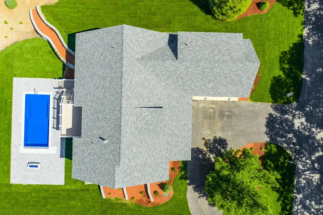 an aerial view of a house with garden space and street view