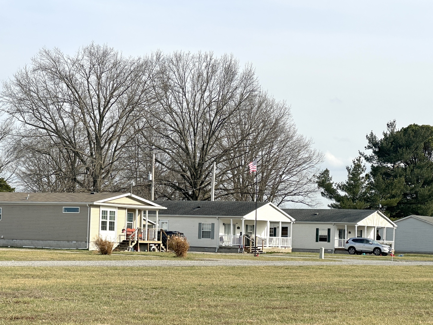 111 Devan Drive Murphysboro, IL 62966 - Photo 5 of 22 a front view of a house with a big yard and potted plants