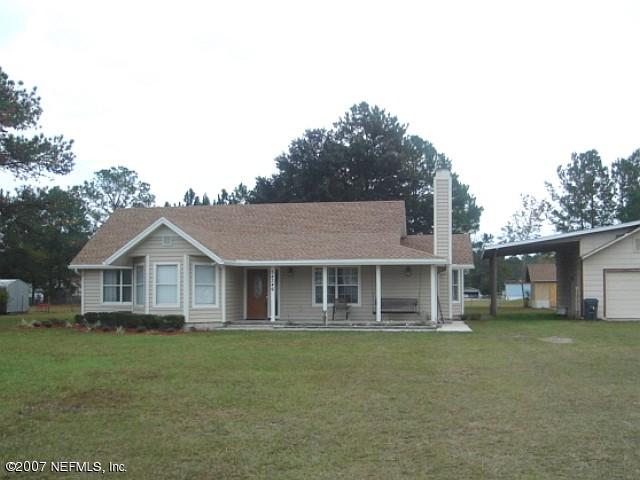 54346 Dornbush Road Callahan, FL 32011 - Photo 1 of 12 a front view of a house with a garden