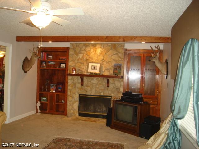 54346 Dornbush Road Callahan, FL 32011 - Photo 2 of 12 a view of a livingroom with a fireplace and cabinet