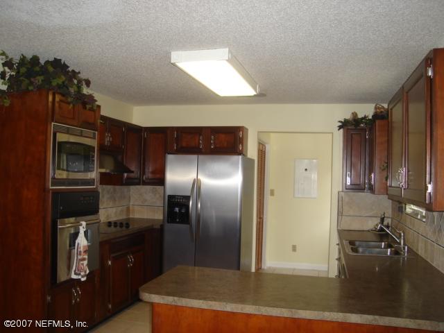 54346 Dornbush Road Callahan, FL 32011 - Photo 5 of 12 a kitchen with refrigerator and window