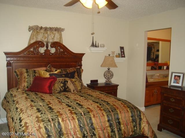 54346 Dornbush Road Callahan, FL 32011 - Photo 6 of 12 a bedroom with a bed and a chandelier