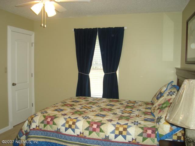 54346 Dornbush Road Callahan, FL 32011 - Photo 8 of 12 a bedroom with a bed and a window